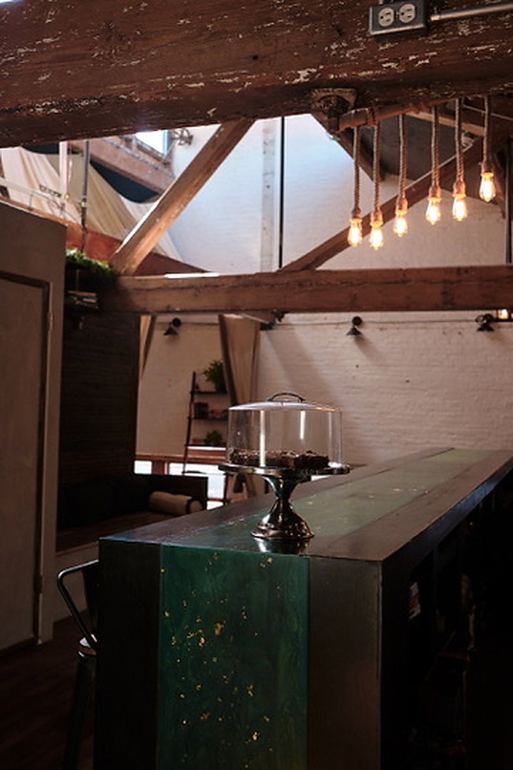 brwnbox bar area beneath exposed beams and pendant lights