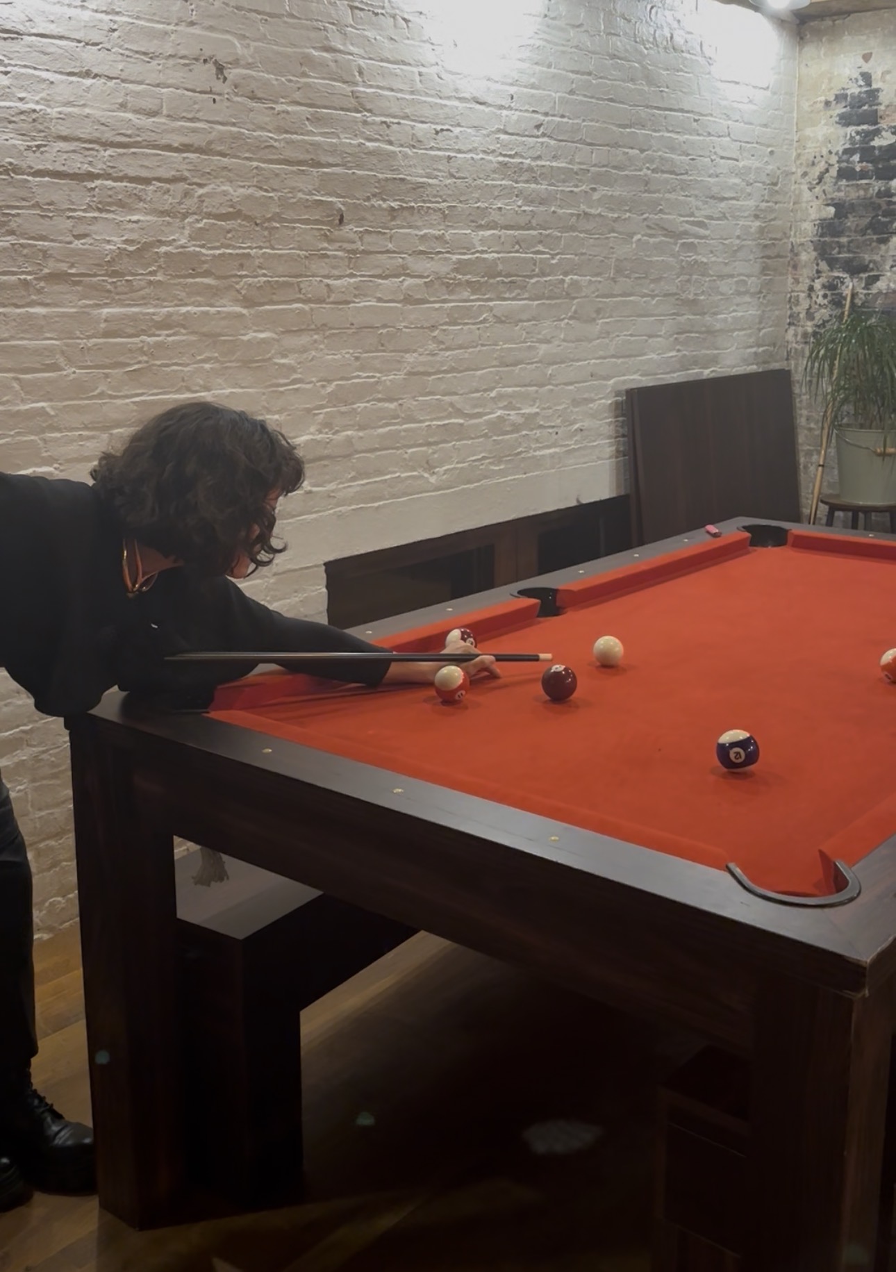 Guest playing pool inside brwnbox