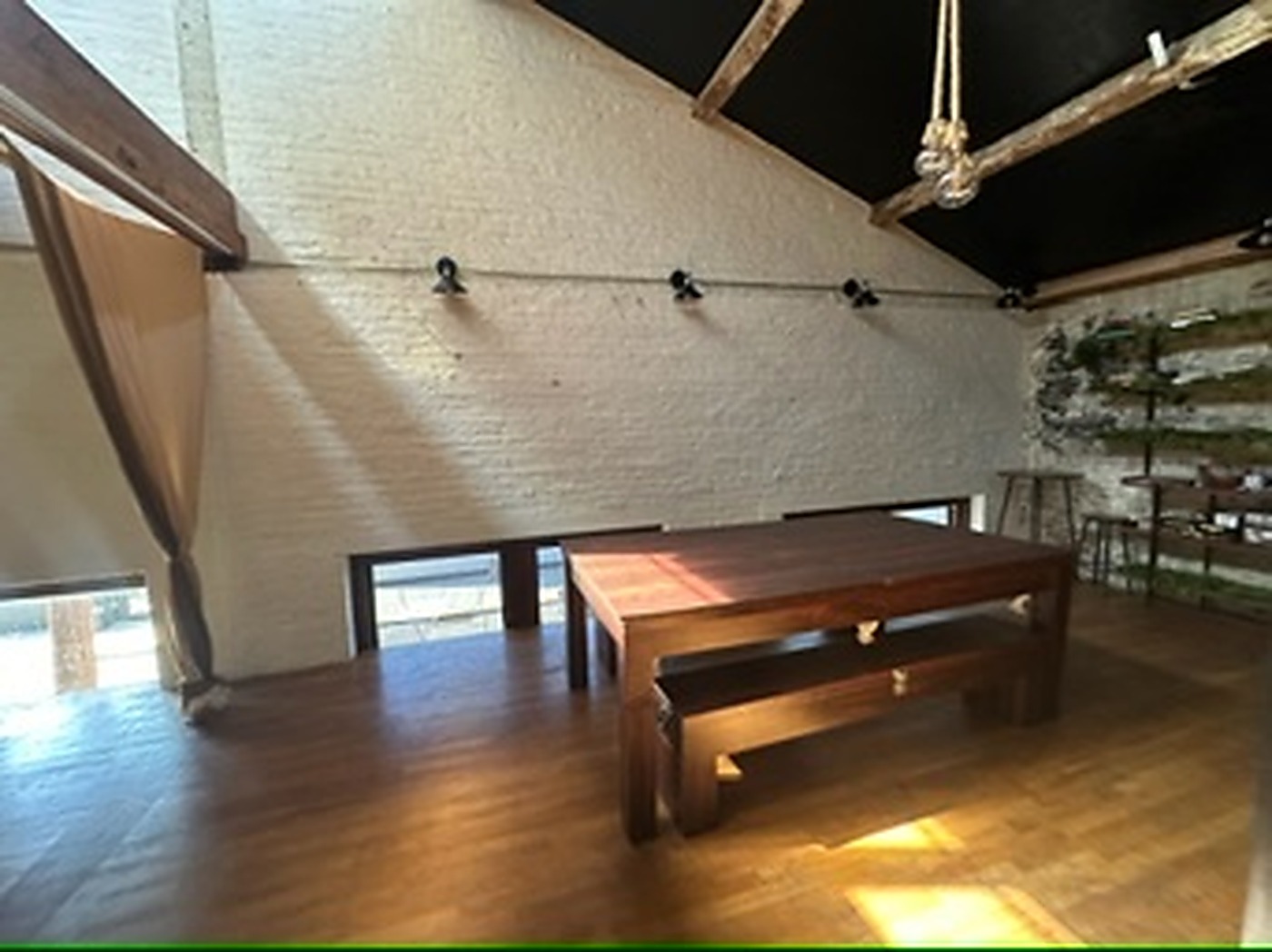 Upper level seating area with long wood table